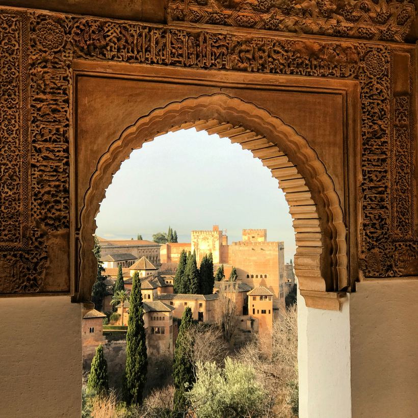 The Alcazaba seen through a carved Moorish arch